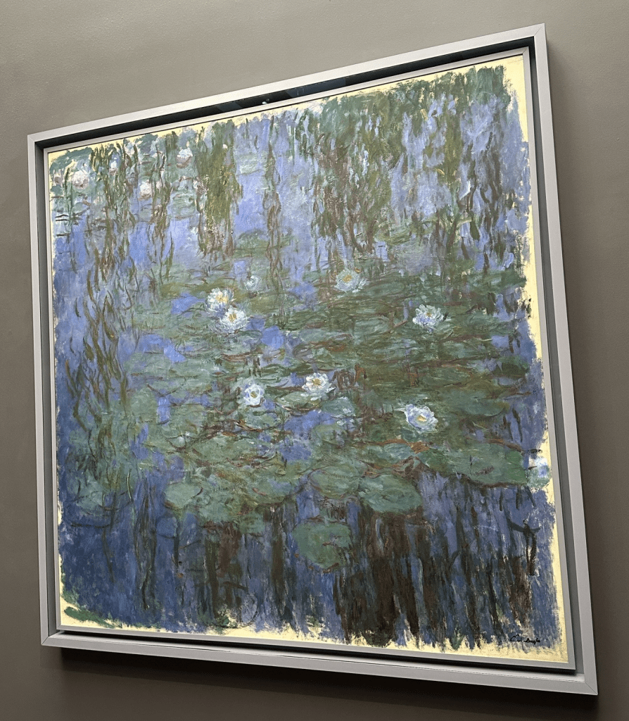 Picture caption: green foliage is reflected in the water. A cluster of white water lilies dominates the front of the painting and a smaller more distant cluster of pink water lilies features in the left back corner.
