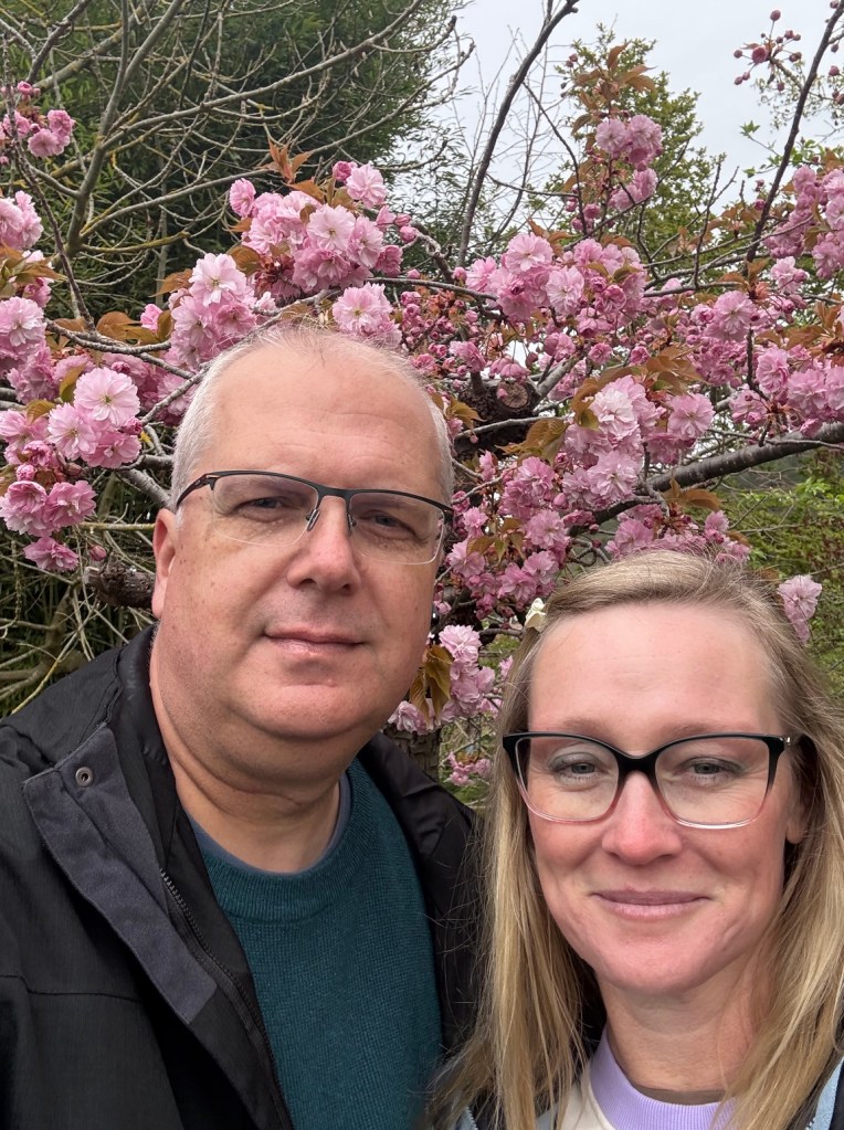 TC and I with a cherry tree in blossom in Monet's Garden in the background