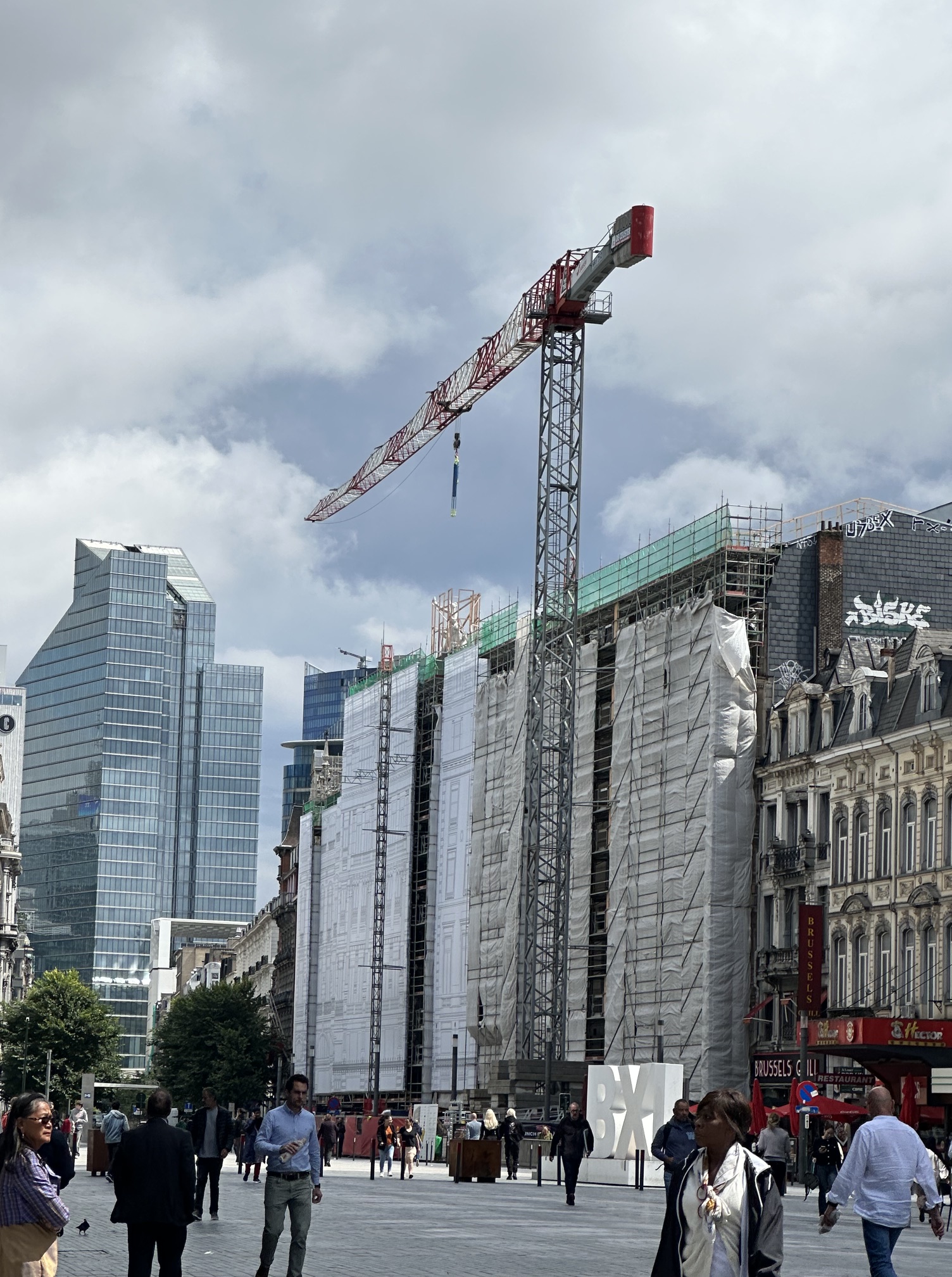A crane in Brussels being used for renovations to a multistory building.