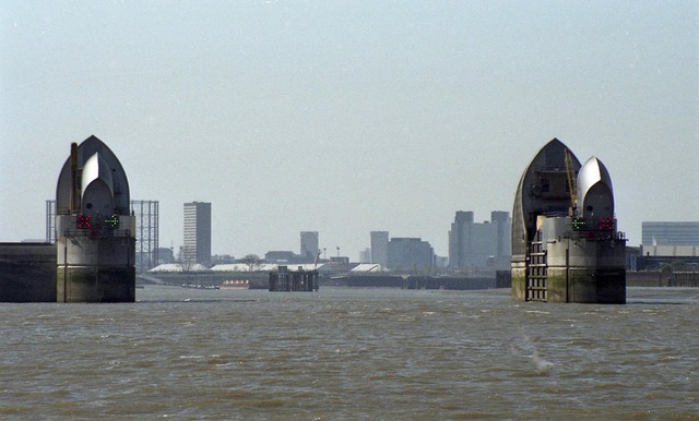 Distance shot of the Thames Barrier and the cranes behind it.
