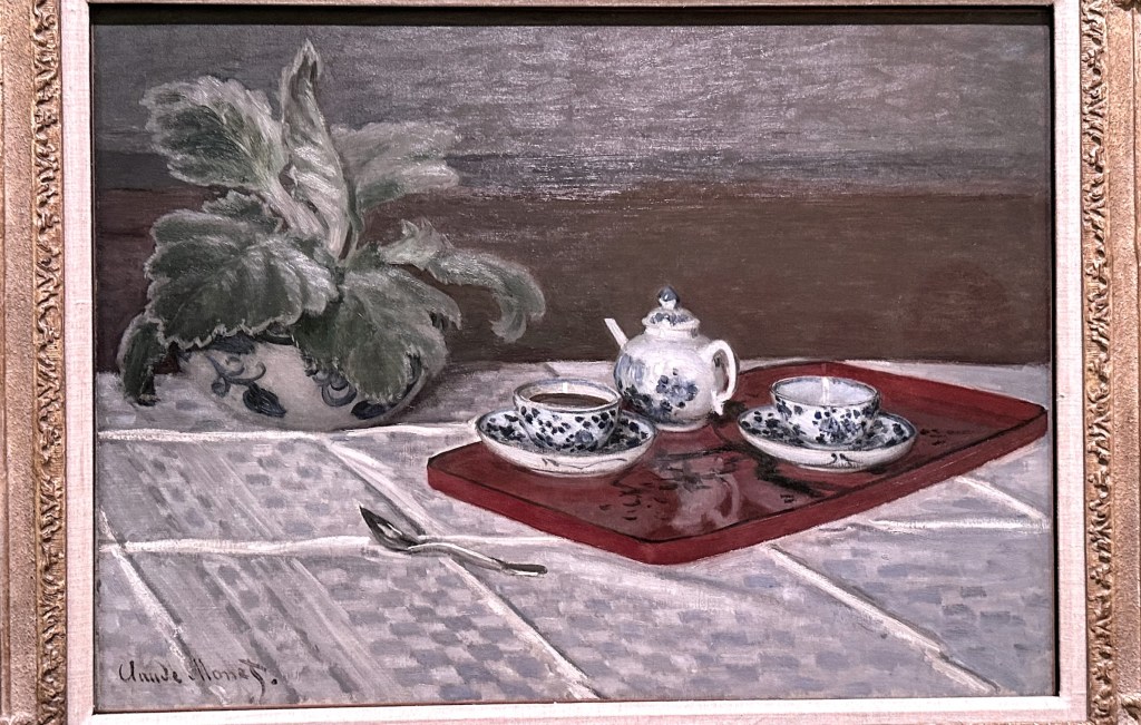A close up of Monet's The Tea Set. If you look closely you can see the reflections of both tea cups and the teapot in the tray in this photograph.